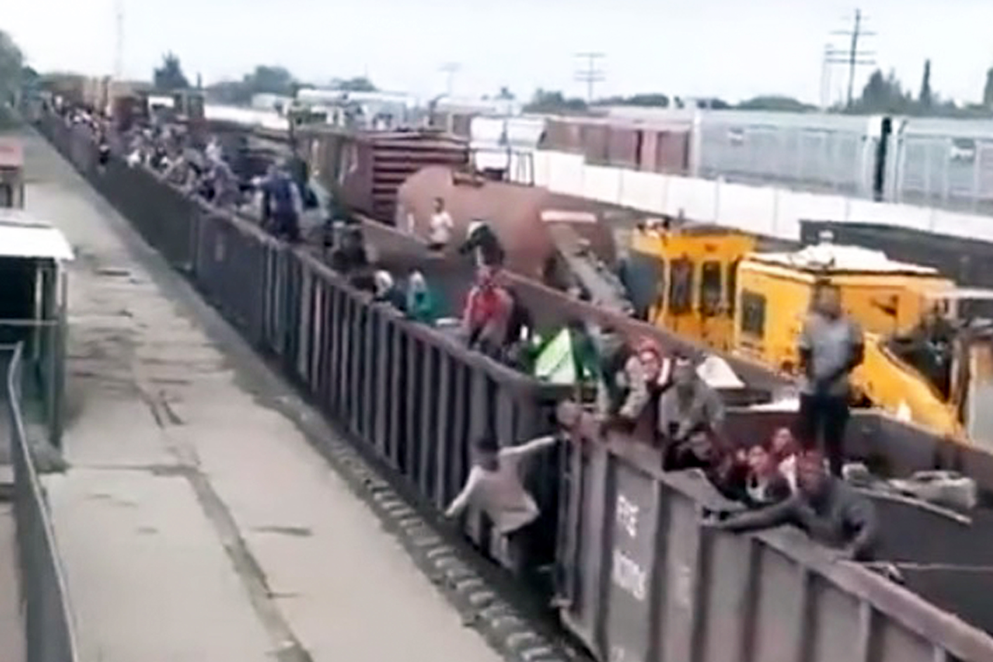Footage shows migrants cheering as they crowd a train from Mexico headed to the US