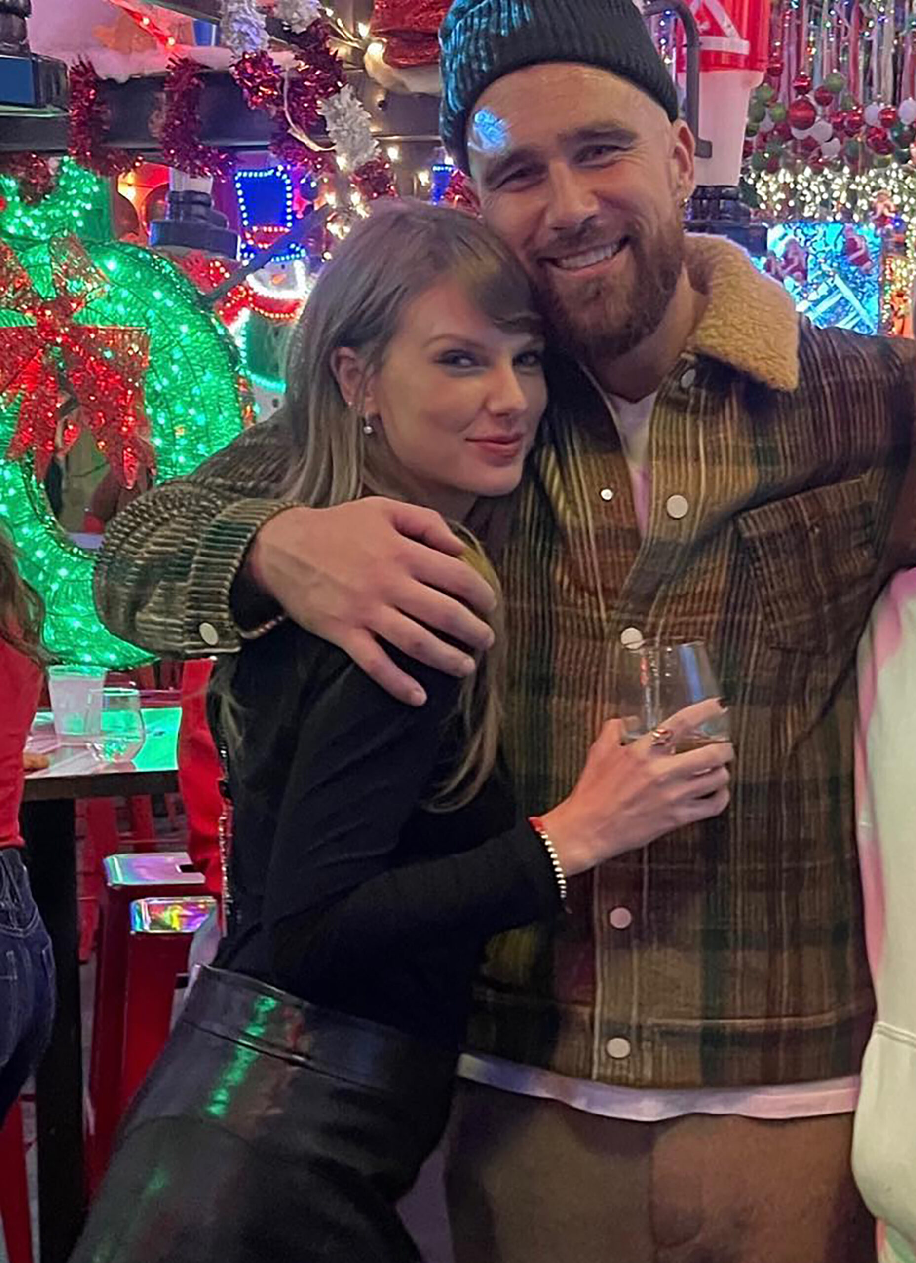 Taylor Swift and Travis Kelce lock lips in steamy new photo from post-game holiday party
