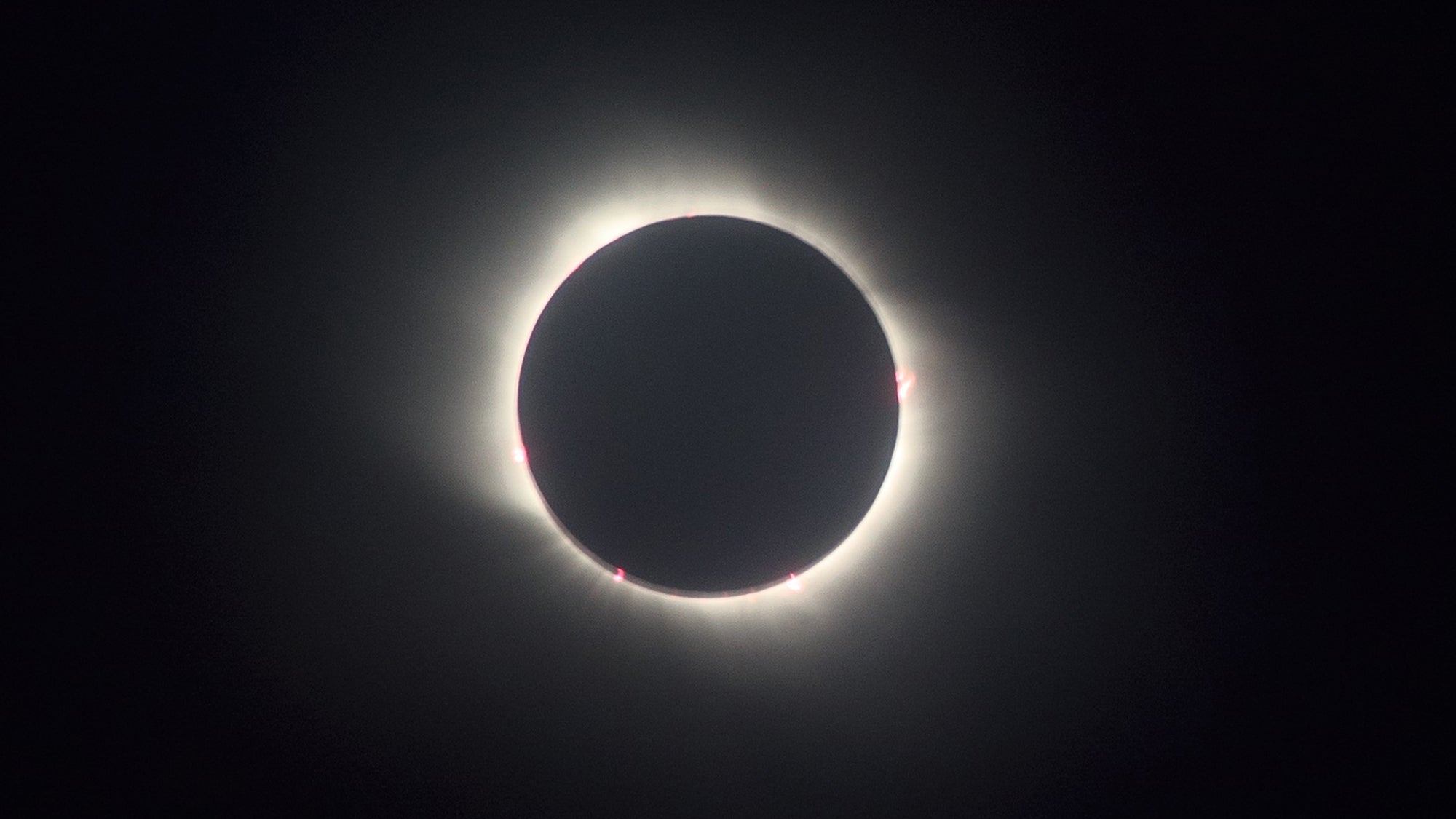 Why do solar eclipses happen?